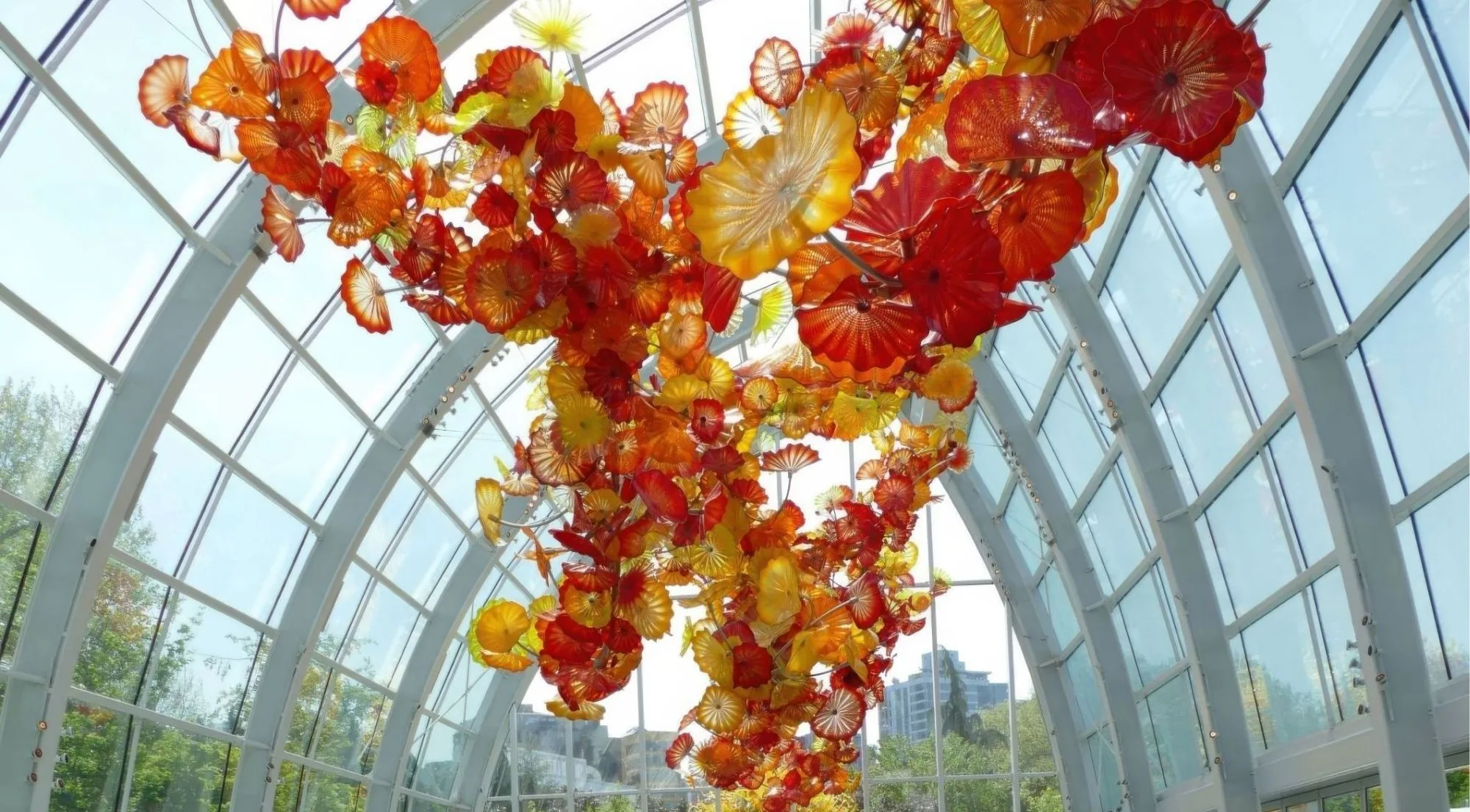 The 100-foot suspended sculpture filling the Glasshouse ceiling in reds, oranges and amber