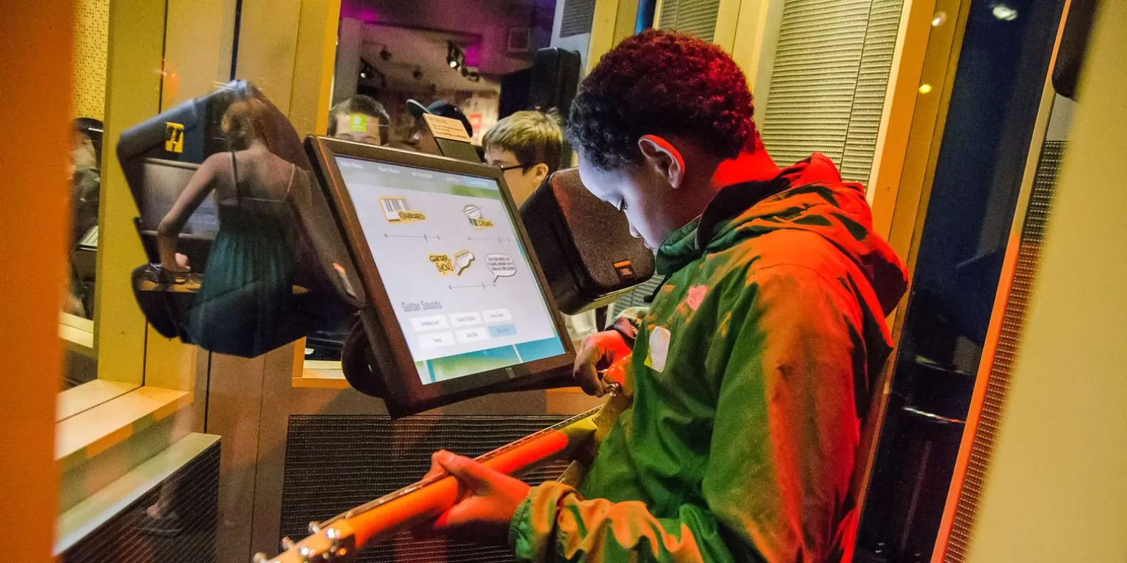 A young visitor using a hands-on interactive exhibit at Pacific Science Center