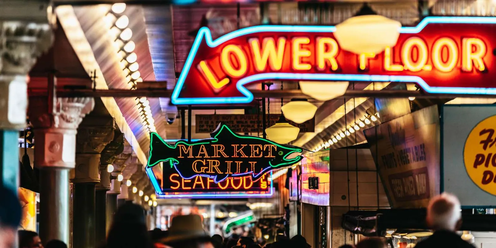 Pike Place Market's neon Lower Floor and Market Grill signs above the arcade